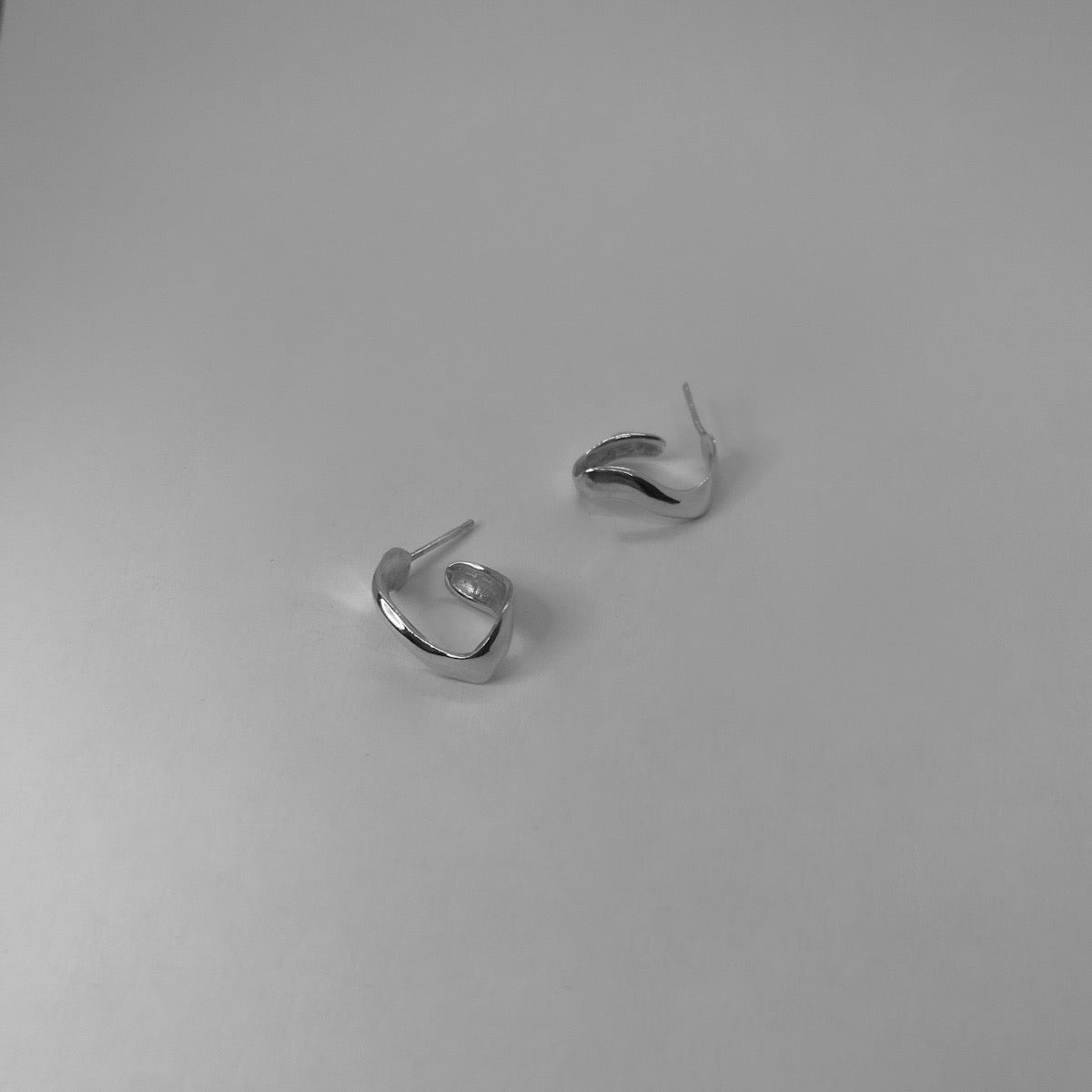 Handmade wavy oval-shaped hoops crafted from sterling silver 925