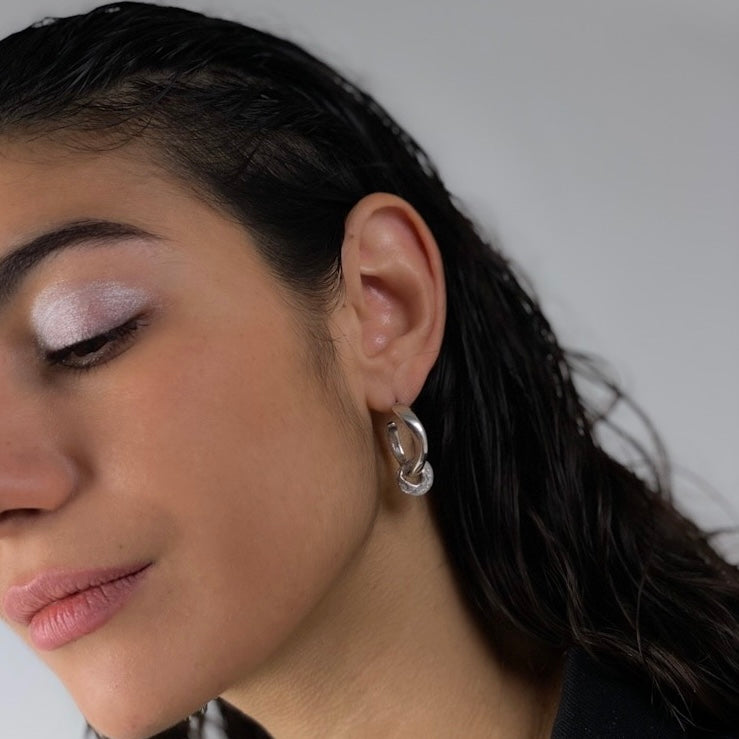 Wavy handmade hoops, one inside the other, made of sterling silver 925
