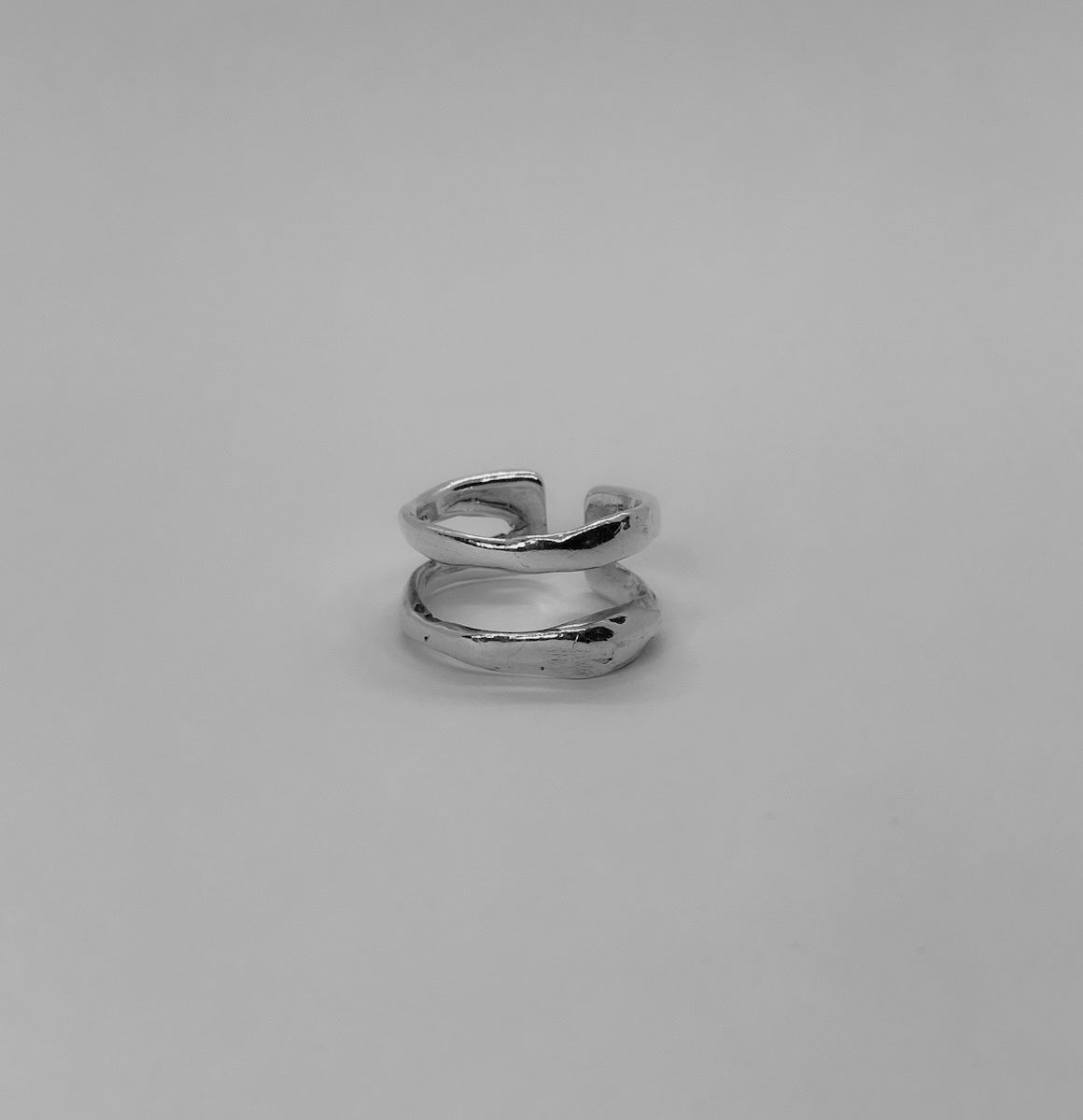 The Oholus ring is a handcrafted piece made of 925 sterling silver. It is composed of two thick silver bands. It is smooth and shiny.