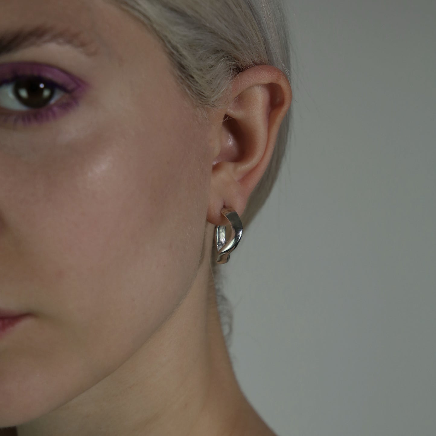 Handmade wavy oval-shaped hoops crafted from sterling silver 925