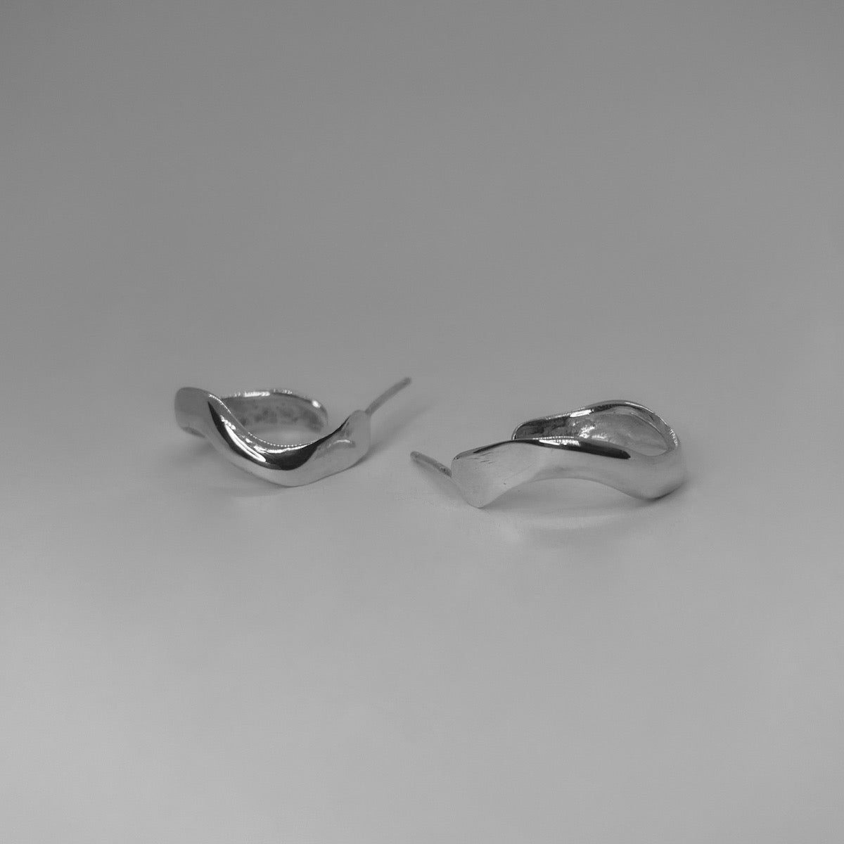 Handmade wavy oval-shaped hoops crafted from sterling silver 925