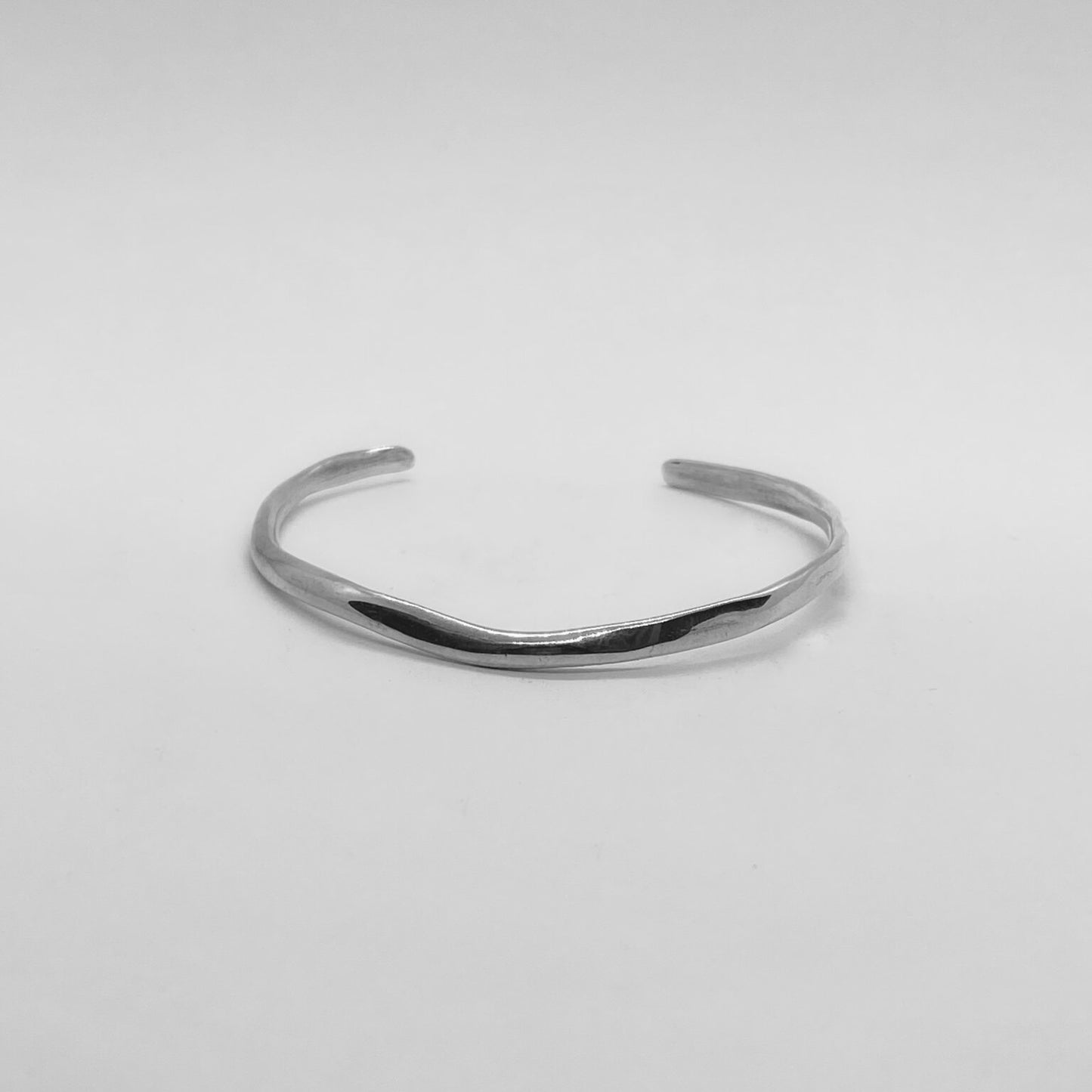 The Branch bracelet is a handmade creation crafted from sterling silver 925, featuring an exquisite and delicate minimal design. It gently fits low on the wrist, providing a smooth and glossy sensation.