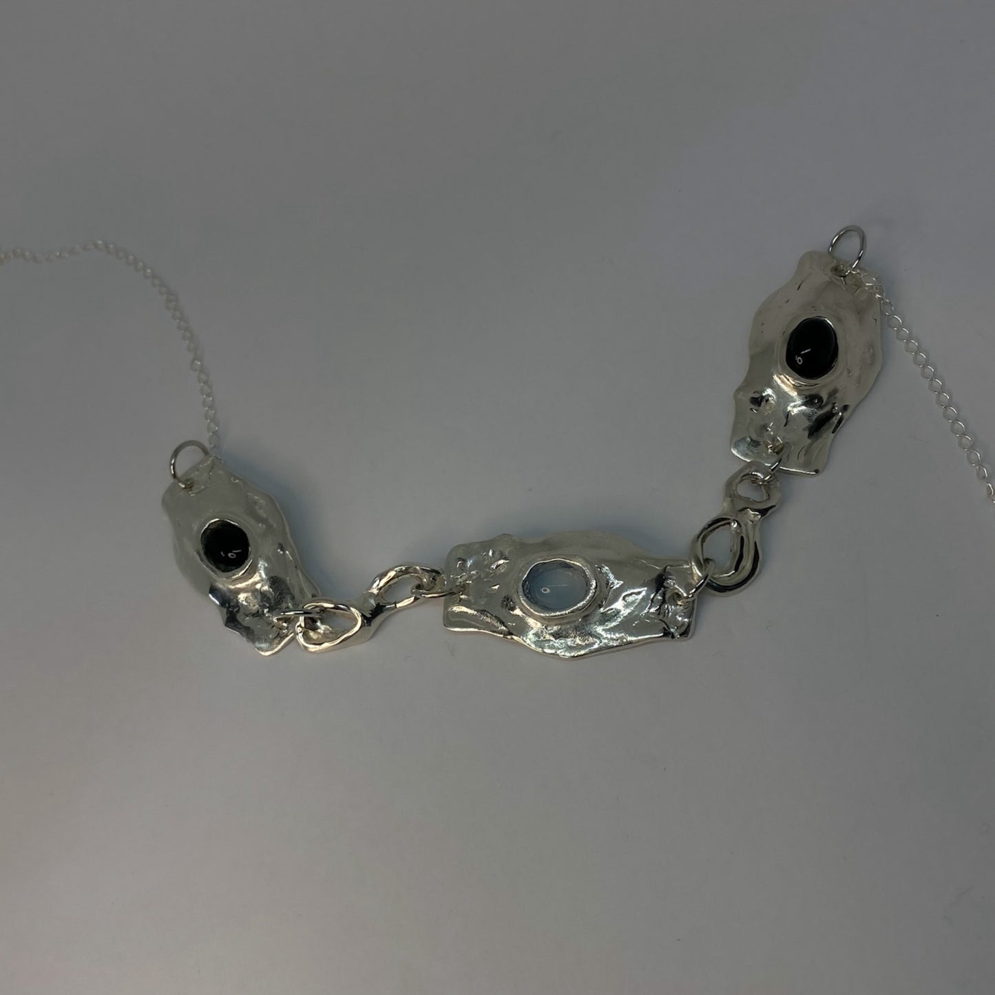 The Denia necklace is handcrafted from 925 sterling silver and adorned with semi-precious stones in various color combinations.