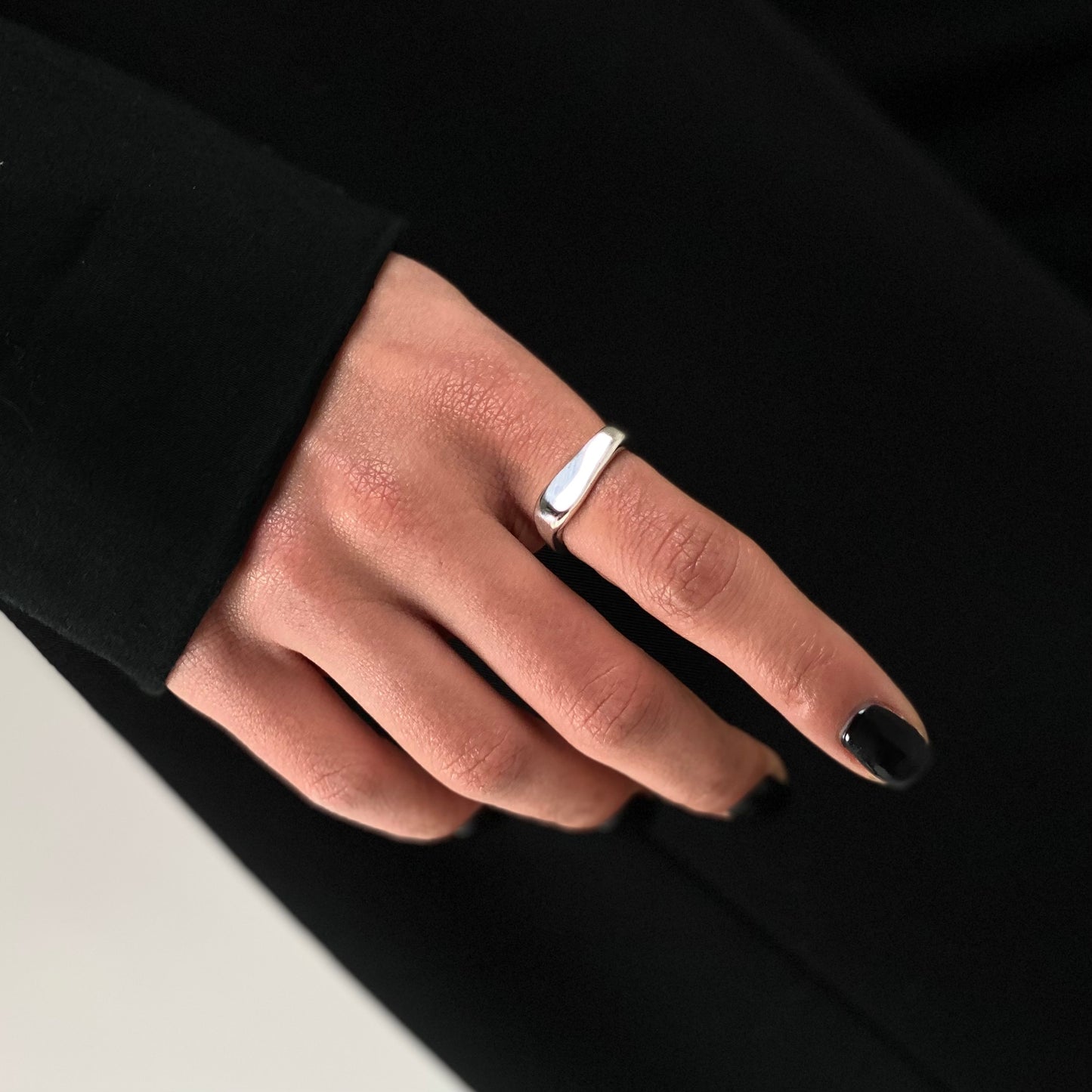 The Passion ring is a handcrafted piece made of 925 sterling silver. Its shape is square, with one edge thicker than the other. It is smooth and shiny