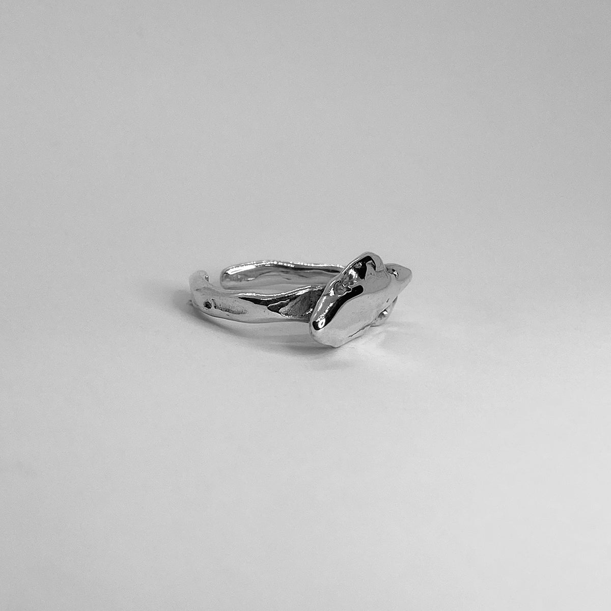 The Nami ring is a handmade piece made of 925 sterling silver. Its surface is raw and glossy