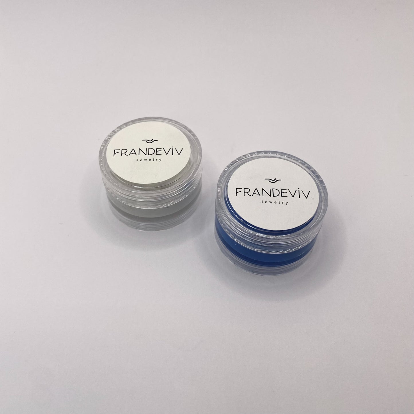 INSTRUCTIONS:
Cut and weigh half the amount of each material (White – Blue).
Knead the two materials together until a uniform color is achieved (1-2 minutes).
Gently press the putty onto the spot you want to take an impression of (nose or paw).
The putty will harden in about 10 minutes.
Place the molds in the plastic containers and send them back to us so we can create your jewelry.
NOTES:
• THE SILICONE CURES QUICKLY. ONCE YOU MIX THE TWO MATERIALS, APPLY IMMEDIATELY. AS THE PUTTY HARDENS, TAKING THE