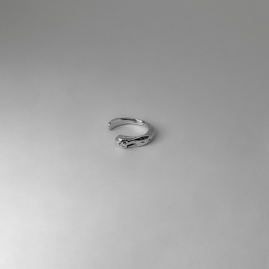 The Lilium ear cuff is handmade and made of 925 silver. Its surface appears to be raw and glossy. It does not require pierced ears.