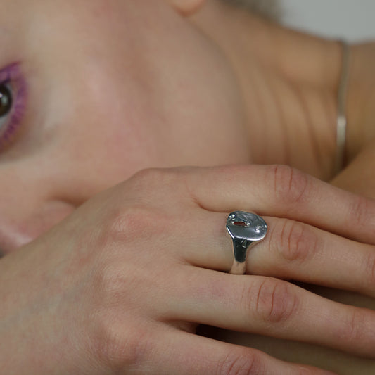 The Slot ring is a handmade piece made of 925 sterling silver. Its surface is raw and glossy.