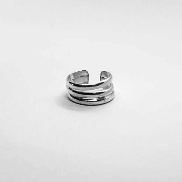 The Lilium Triple ring is a handcrafted piece made of 925 sterling silver. It consists of three silver bands, with a small opening at the edge, giving it a smooth and shiny appearance