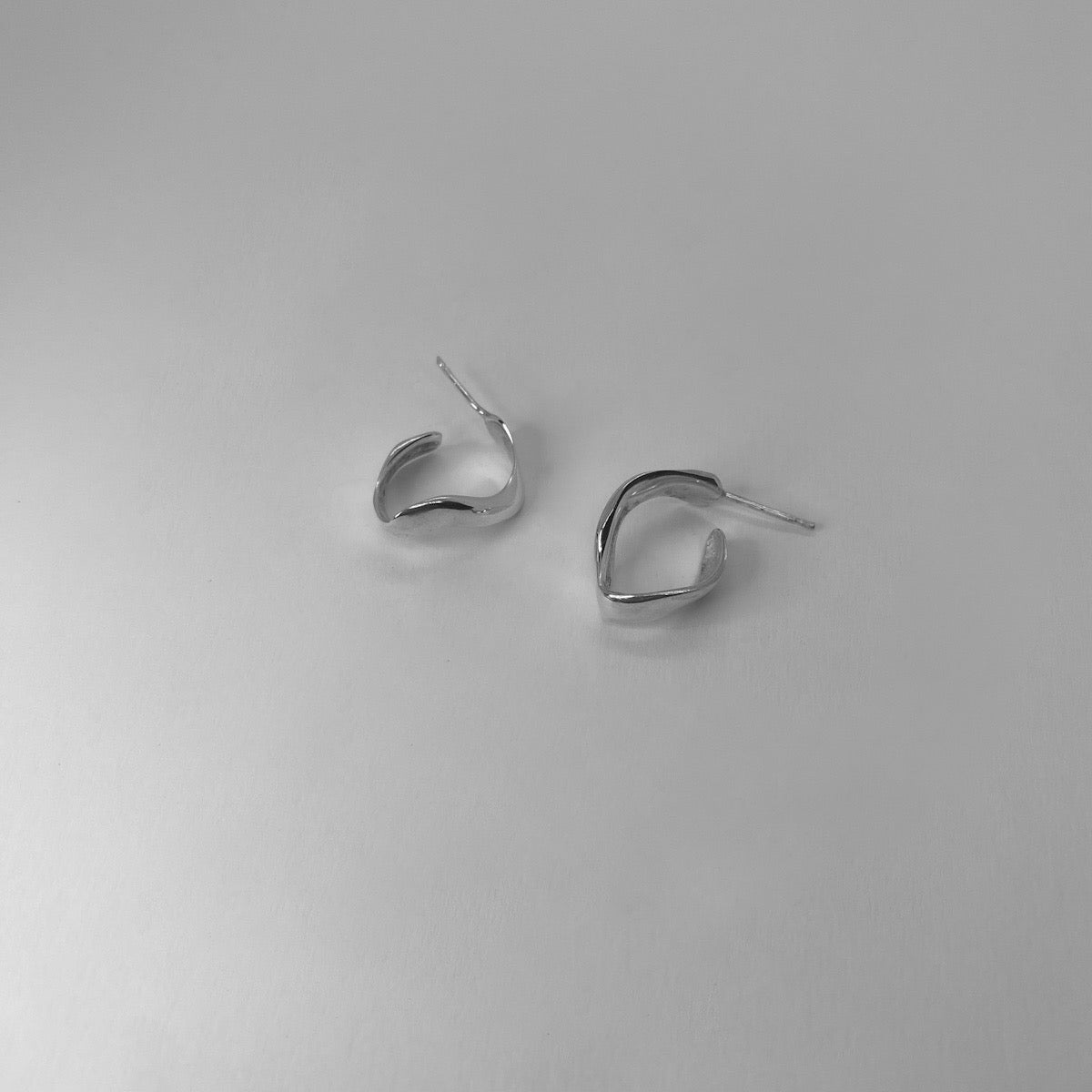 Handmade wavy oval-shaped hoops crafted from sterling silver 925