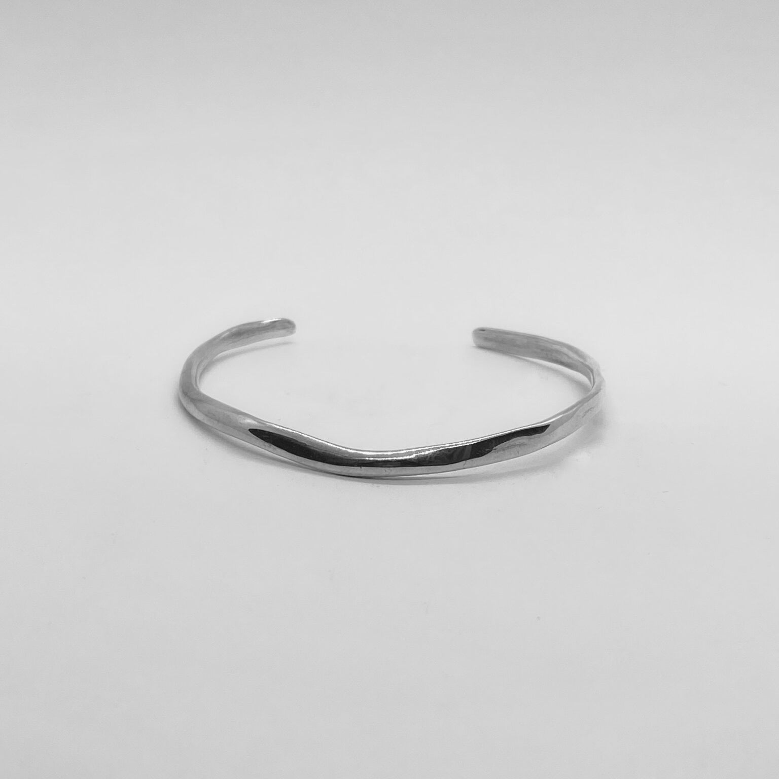 The Branch bracelet is a handmade creation crafted from sterling silver 925, featuring an exquisite and delicate minimal design. It gently fits low on the wrist, providing a smooth and glossy sensation.