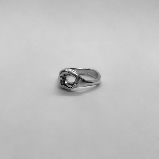 A handmade ring made of 925 sterling silver. In the center, there is an open circle that is both hollow and glossy.