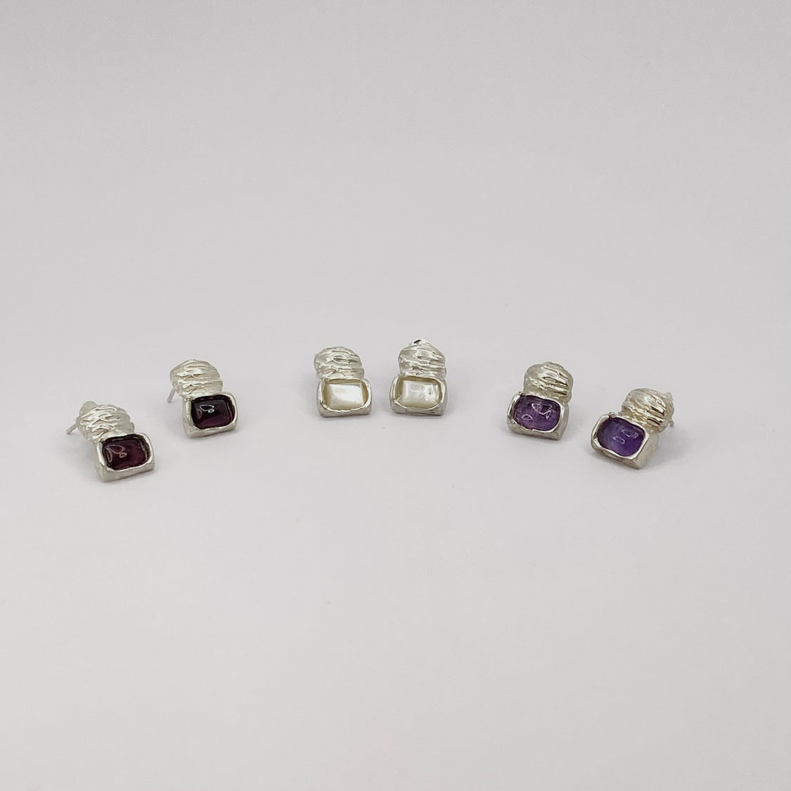 Handcrafted 925 Sterling Silver Eve Earrings

Material: 925 Sterling Silver

Stone: Semi-precious gemstone

Gemstone Color Options: Red Ruby, Purple Amethyst, or White mother of pearl

Closure: Post with sterling silver butterfly back

Quantity: Sold as a pair

Finish: Smooth, polished finish

Craftsmanship: 100% Handcrafted in Greece
Production: Made to order

Shipping: Ships within 5–10 business days

Each piece of jewelry is individually handcrafted and unique. Slight variations may occur, reflecting the