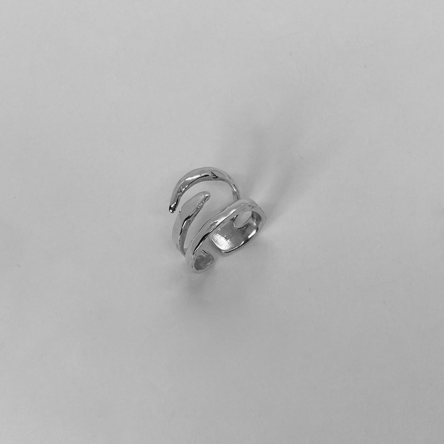 The Spinus ring is a handcrafted piece made of 925 sterling silver. It is composed of three silver bands and is smooth and glossy