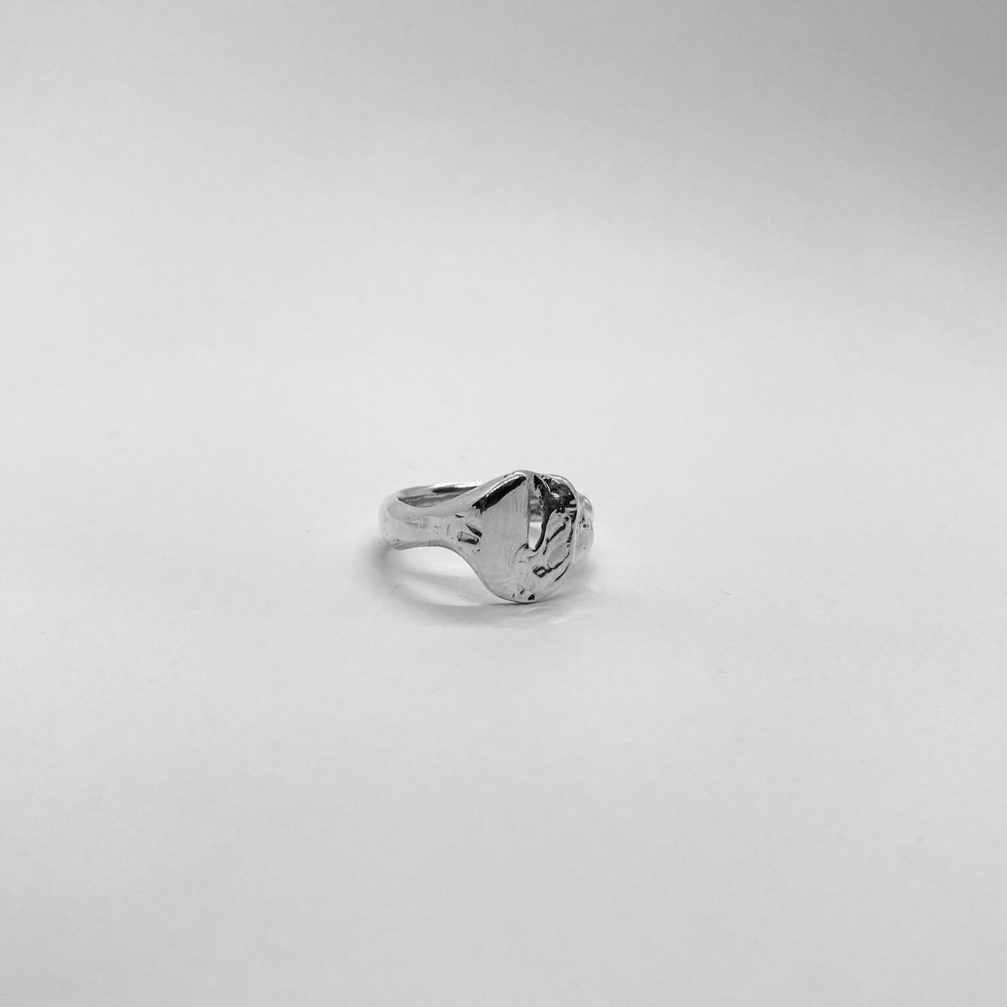 The Slot ring is a handmade piece made of 925 sterling silver. Its surface is raw and glossy.