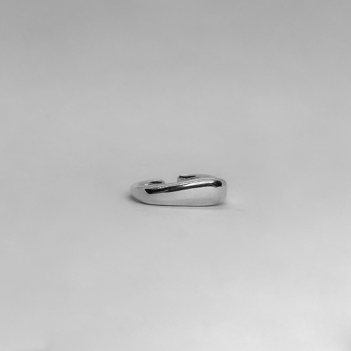 The Passion ring is a handcrafted piece made of 925 sterling silver. Its shape is square, with one edge thicker than the other. It is smooth and shiny