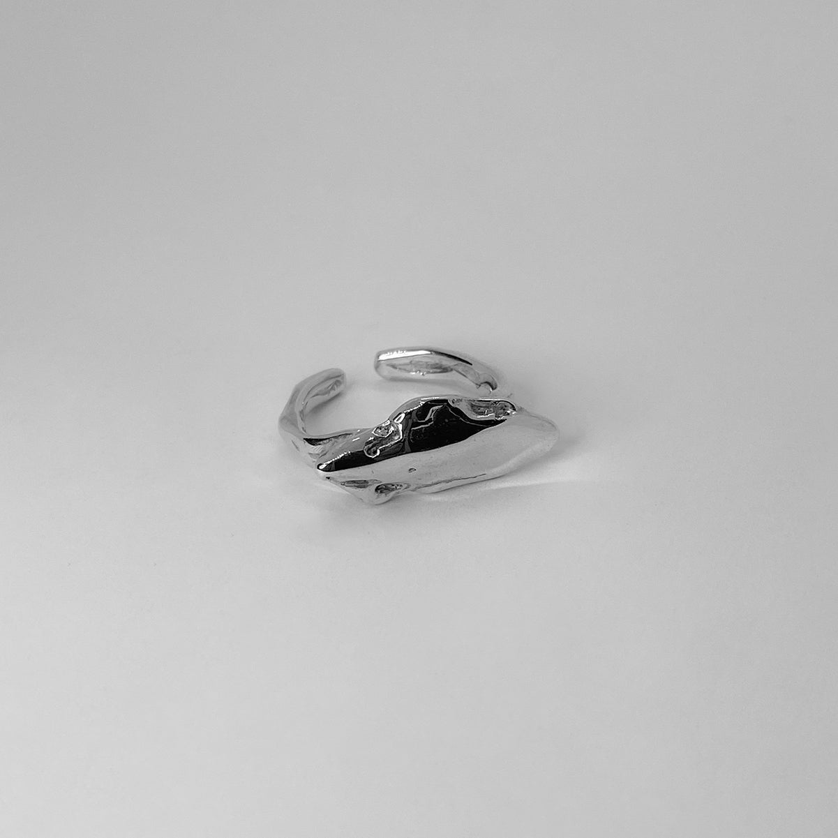 The Nami ring is a handmade piece made of 925 sterling silver. Its surface is raw and glossy