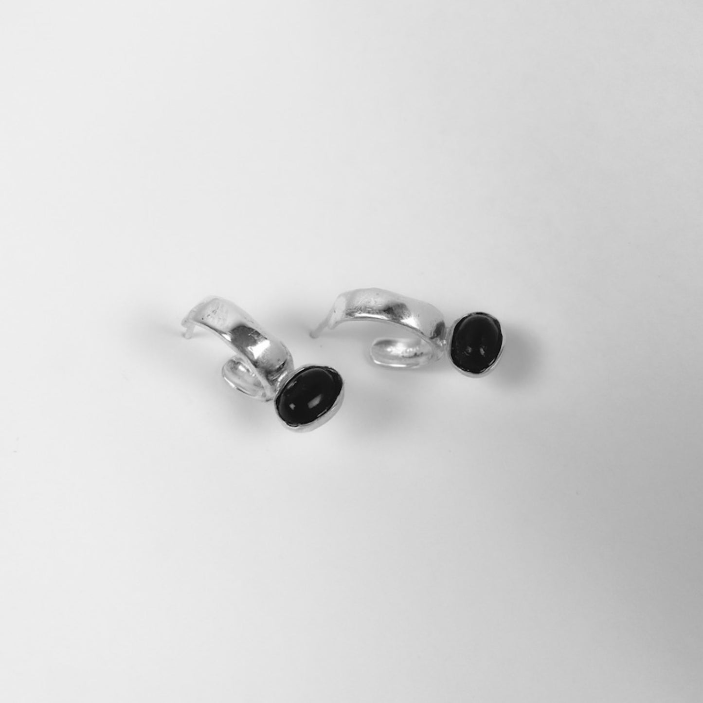 The small circle earrings are handmade and crafted from sterling silver 925. The accompanying stone is semiprecious and is available in three colors: white Haolite , green Agate and black agate. The earrings are smooth and glossy.